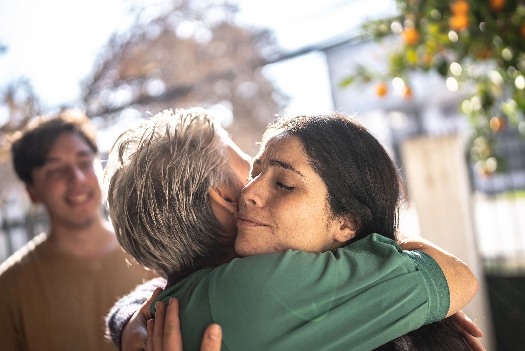 Smiling person greeting someone at home