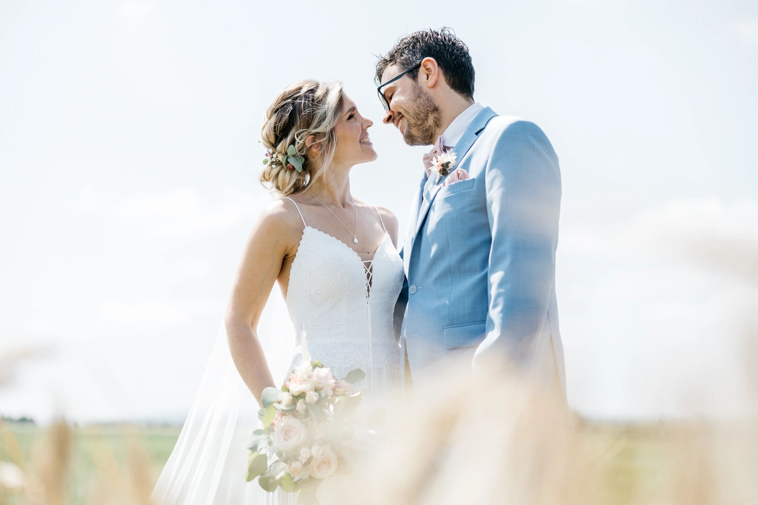 Bride and groom photographed outdoors in warm natural light