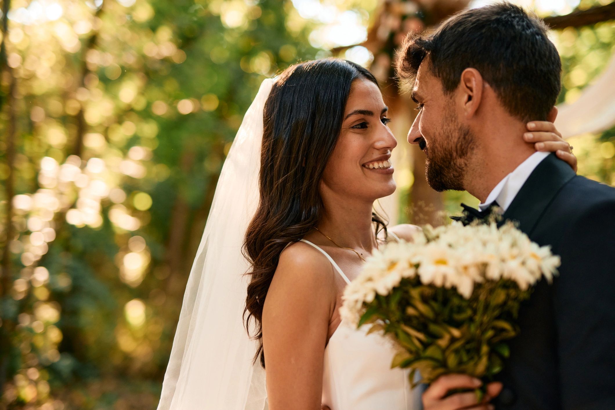 Bride and groom sharing a tender moment outdoors