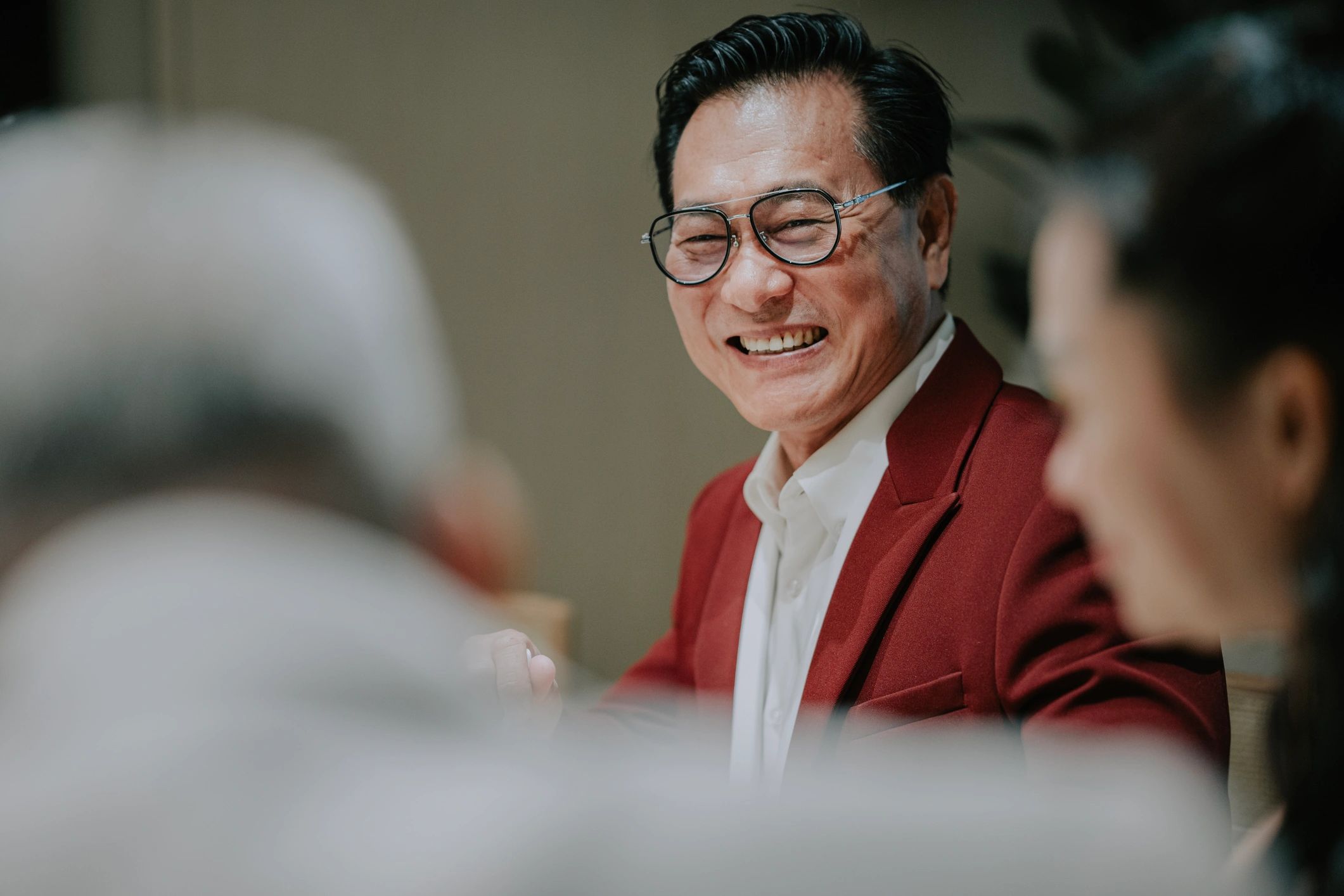 Person smiling during a conversation at a business dinner