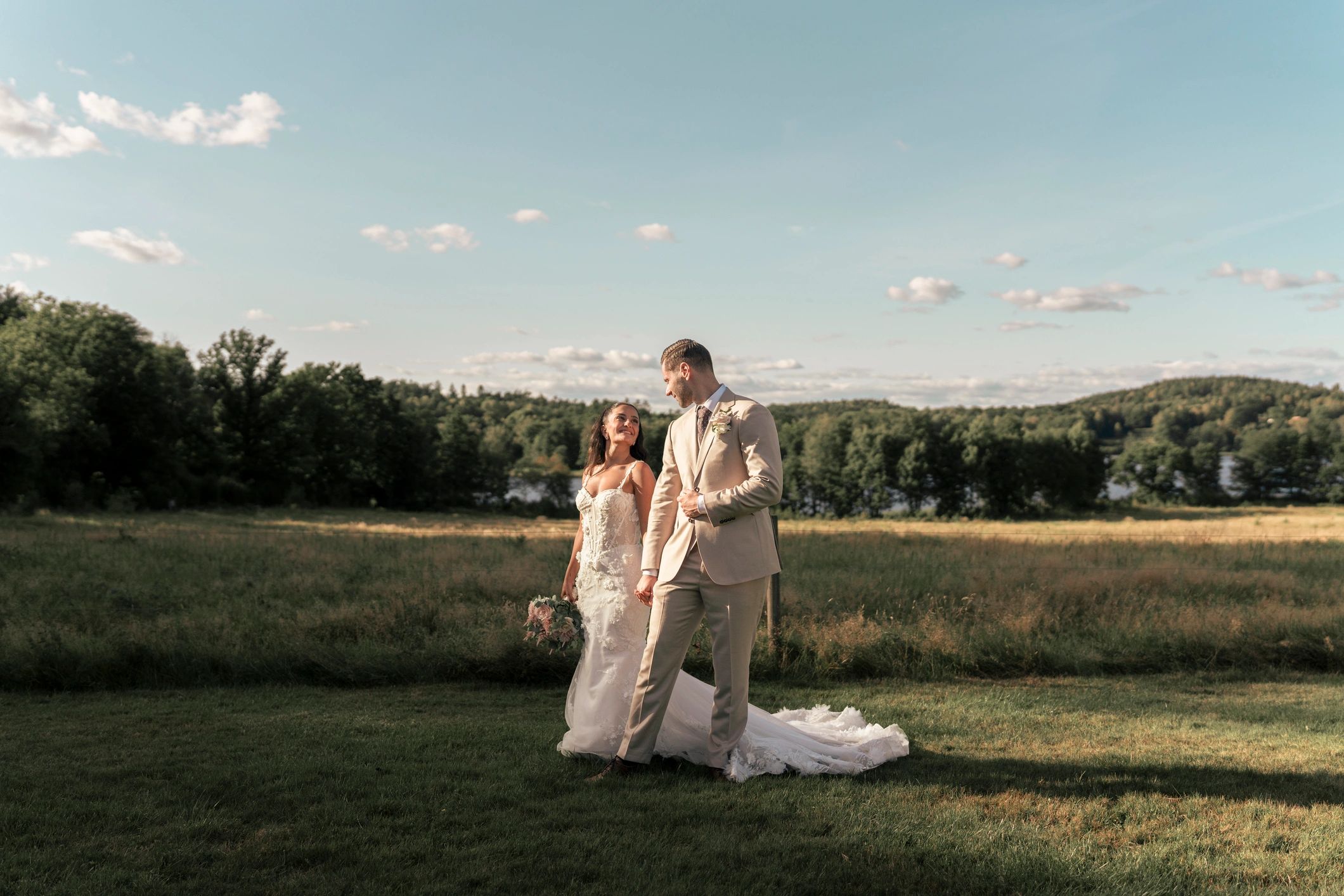 Couple walking hand in hand in a meadow